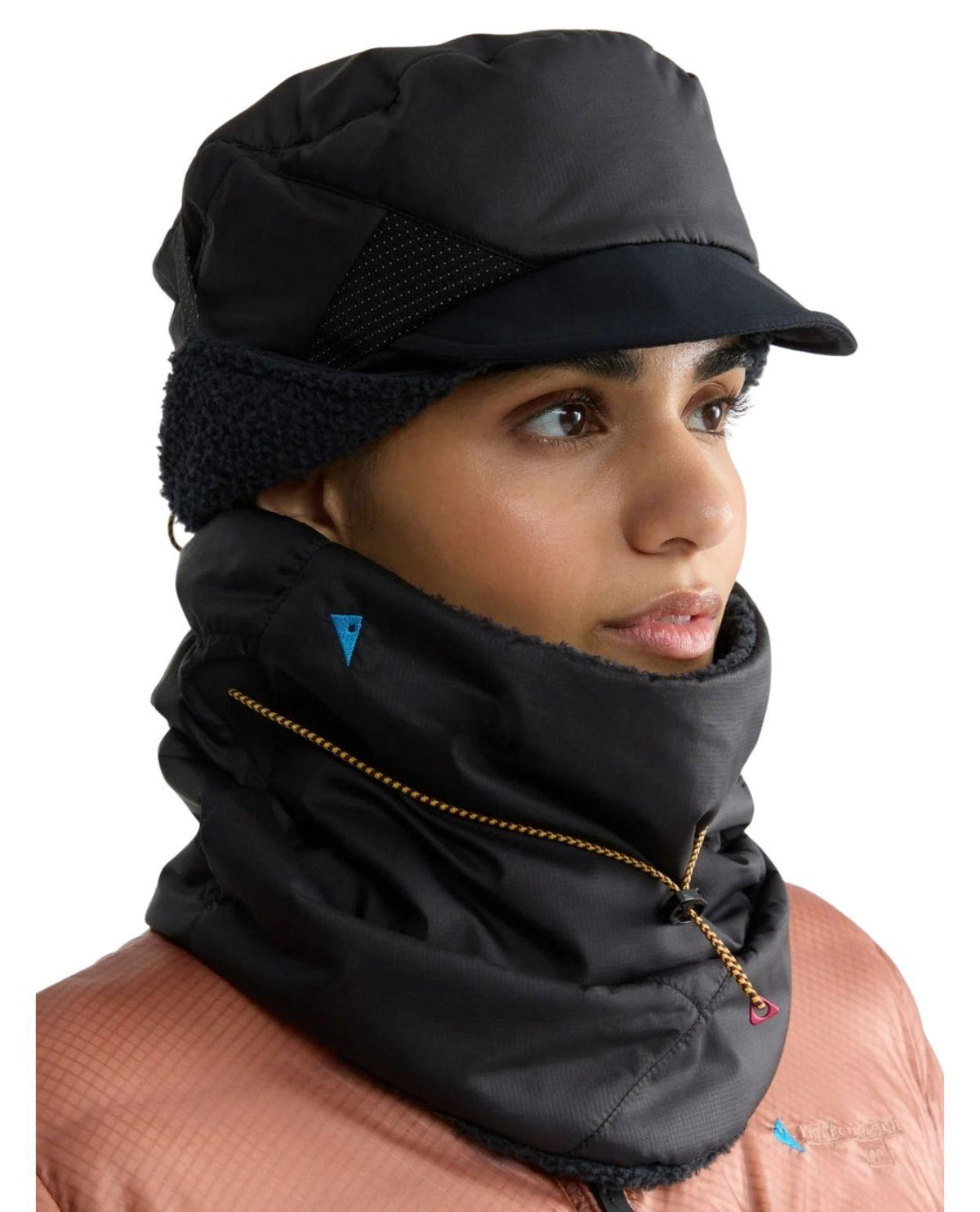 Skidåkare som bär svarta Klättermusen Viglaf Neck Gaiter och matchande keps för kalla dagar på berget.