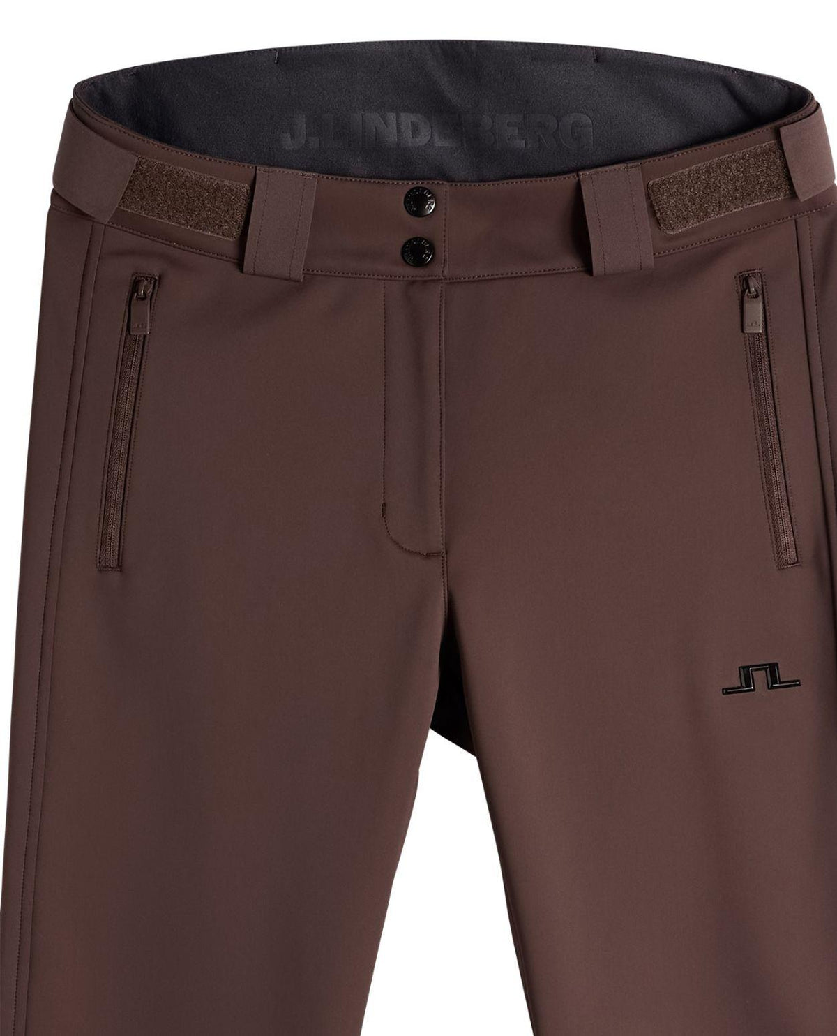 Närbild på J.Lindeberg Stanford Softshell Skidbyxor Dam i färgen Seal Brown med fokus på midjan och dragkedjefickor.