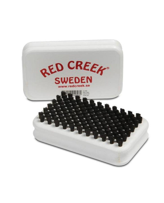 Red Creek vallaborste med svarta borst och vit baksida med röd logotyp.
