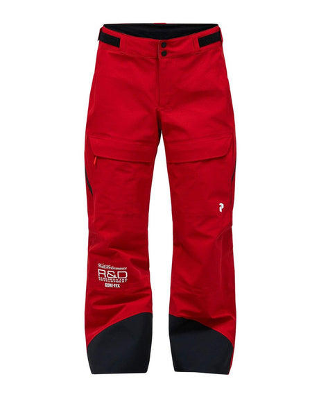 Peak Performance 40Y R&D Gore-Tex skidbyxor dam i rosa med tekniska detaljer.