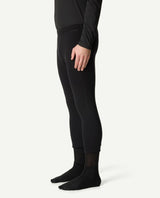 Svart underställsbyxa i modell drop knee från Houdini för herrar, visad från sidan på stående modell.