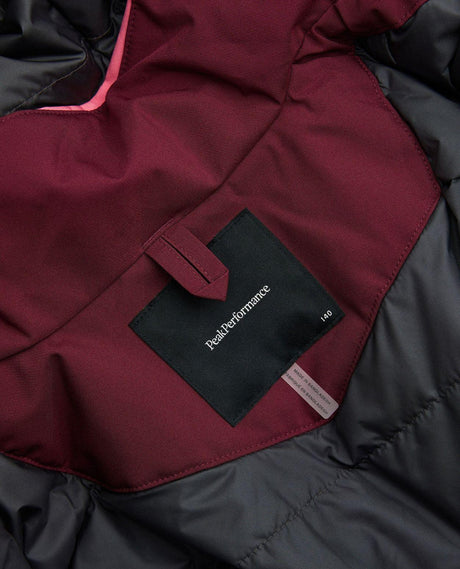 Närbild på inneretikett och logotyp i Peak Performance Gravity Insulated Jacket Junior.