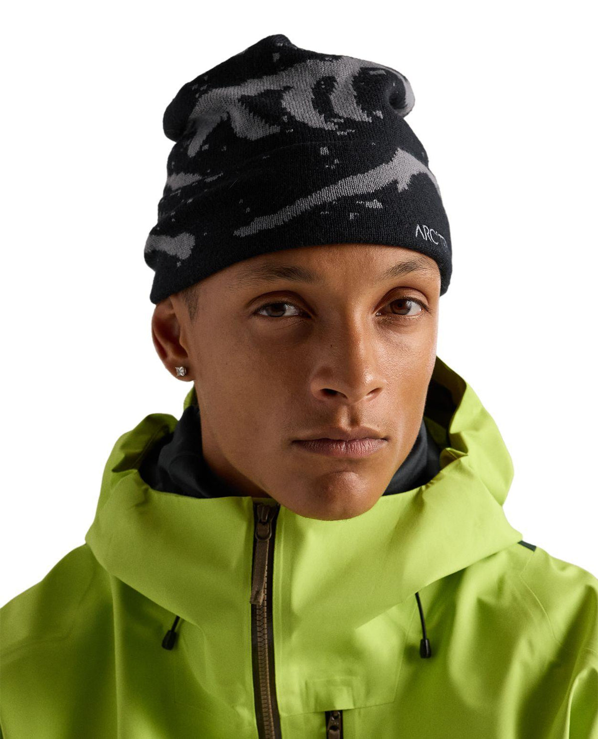 Arc'teryx Grotto Toque i svart och void, bärd av en modell i grön jacka.