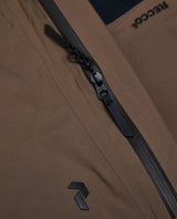 Detaljbild på vattentäta dragkedjor och Recco-reflektor på Peak Performance Alpine Gore-Tex Insulated Skidbyxor Dam Brun.