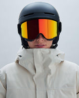 POC Nexal skidglasögon i Uranium Black med Partly Sunny Orange spegellins och matchande svart hjälm.