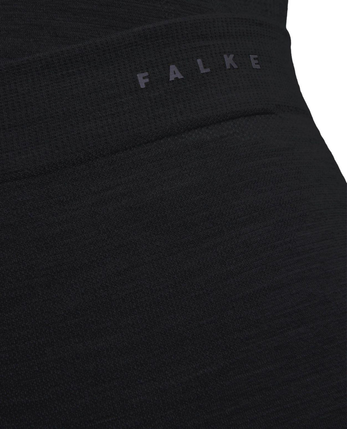 Närbild på Falke Wool-Tech Light 3/4 Tights för dam i svart med synlig logotyp på linningen.