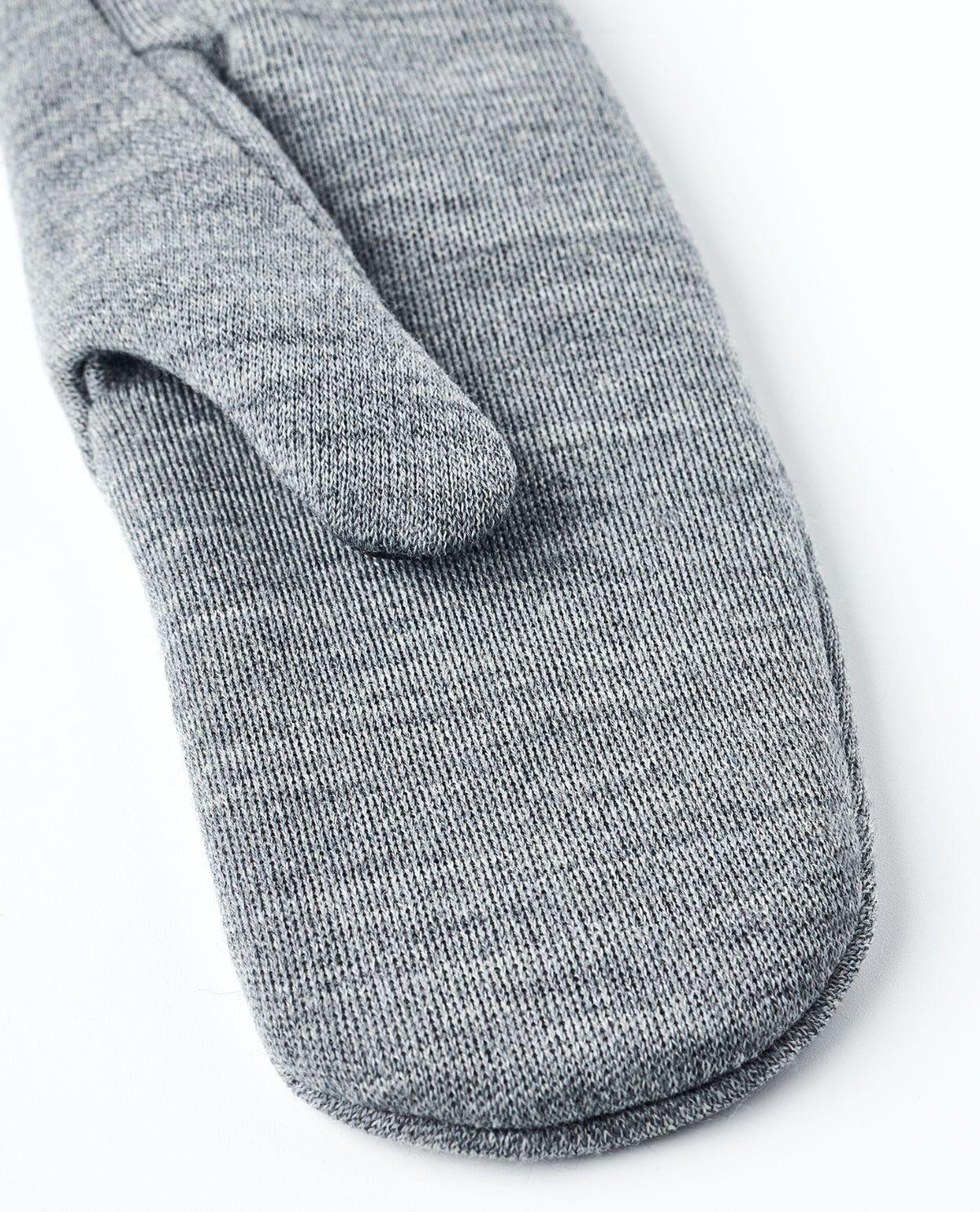 Närbild på Hestra Gravita Merino Liner Mitt i grått med stickad merinoullstruktur.